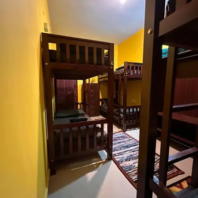 a room with several bunk beds in a room at Rastafari - The Backpackers Hostel in Ooty