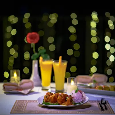 a plate of food on a table with drinks at Vedic Village Retreat Kodungallur in Cochin