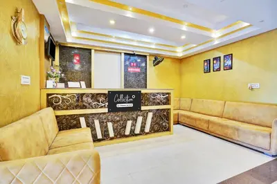 a waiting room with brown leather couches and a sign at Super Collection O Kushal Nagar Near KSRTC Bus Stand in Madikeri