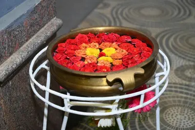 a pot of flowers sitting on top of a table at Bridge Point Home Stay in Kushālnagar