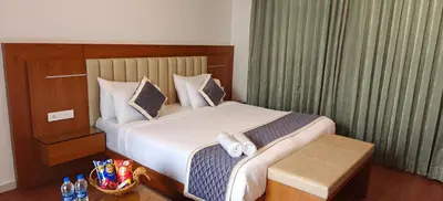 a hotel room with a bed with towels on it at S R Private Residence in Mysore
