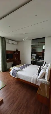 a bedroom with a large bed and a mirror at S R Private Residence in Mysore
