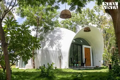 a dome house in the middle of a yard at StayVista at Shwaas 4BR Mysore with Private pool and landscape in Mysore
