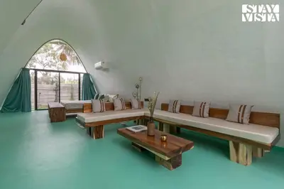 a living room with couches and a table at StayVista at Shwaas 4BR Mysore with Private pool and landscape in Mysore