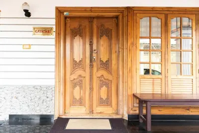 a wooden door with a table in front of it at Jaalakam Retreat in Trichūr