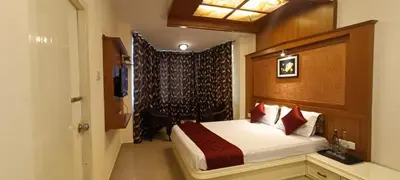 a hotel room with a bed and a window at Quick Sort Residency in Ooty