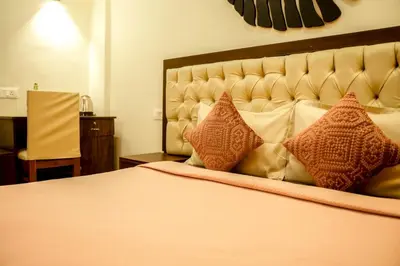 a bedroom with a large bed with pillows on it at The Cove Lakkidi in Vythiri