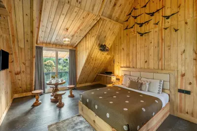 a bedroom with a bed in a wooden cabin at The Cove Lakkidi in Vythiri