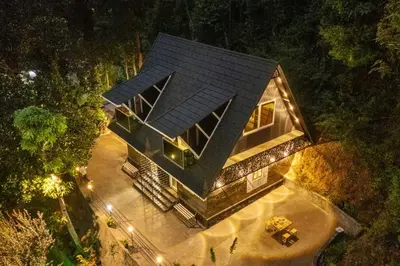 an overhead view of a house in the woods at night at The Cove Lakkidi in Vythiri
