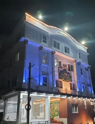 a building with blue lights on the side of it at Amma Inn Elegance Suites and Apartments in Mysore