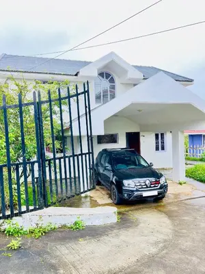 a car parked in front of a house at Teyt's White Home - 3 bedroom Villa in Ooty
