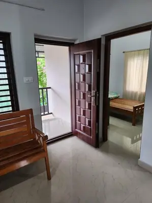 a room with a door and a bench in a room at Padua Building in Irrity