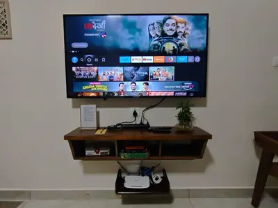 a flat screen tv hanging on a wall at 7 Elysee Homestay - Onyx - Premium 3BHK Family Flat in Trichūr