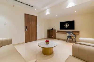a living room with a couch and a table at Royal Embassy in Erode