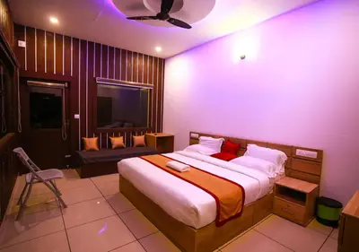 a bedroom with a large bed with red pillows at Wildside Wayanad in Wayanad