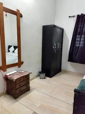 a room with a mirror and a dresser and a mirror at Green Island Homestay Riverside in Kozhikode