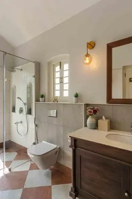 a bathroom with a toilet and a shower and a sink at LohonoStays Villa Lansdowne in Coonoor