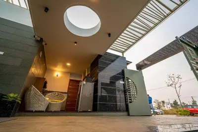 a house with a large window and a building at S R Pool Suites in Mysore