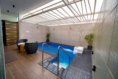 a indoor swimming pool in a building with at S R Pool Suites in Mysore