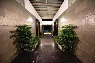 an empty hallway with plants in a building at S R Pool Suites in Mysore
