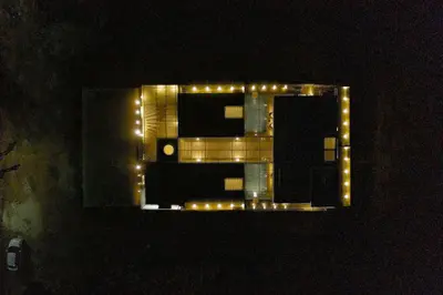 a building with lights on top of it at night at S R Pool Suites in Mysore
