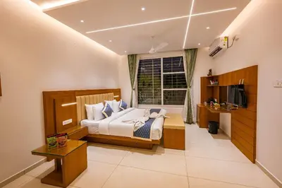 a bedroom with a bed and a window at S R Pool Suites in Mysore