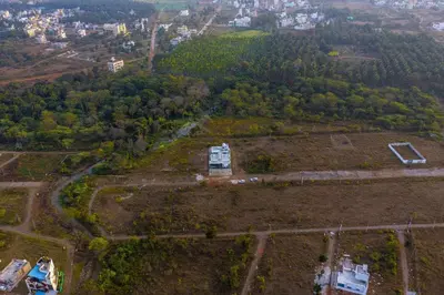 an aerial view of a field with a house on it at S R Luxury Stays in Mysore