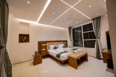 a bedroom with a large bed and a window at S R Luxury Stays in Mysore