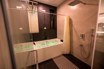 a bathroom with a bath tub and a shower at S R Premium Suites in Mysore