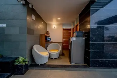 a bathroom with two toilets and a refrigerator at S R Premium Suites in Mysore
