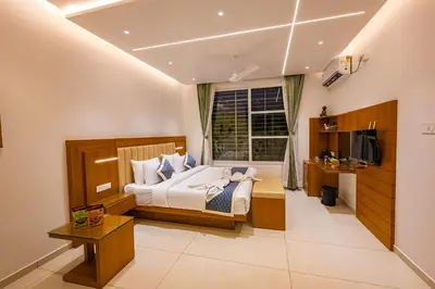 a bedroom with a bed and a window at S R Spa Suites in Mysore