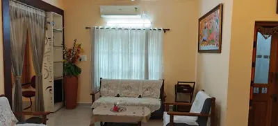 a living room with a couch and a chair at S R Villa Mysore in Mysore