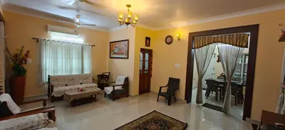 a living room with a couch and a table at S R Villa Mysore in Mysore