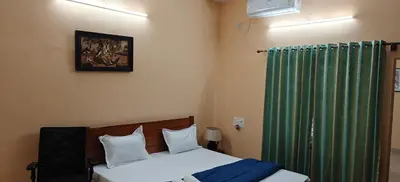 a bedroom with a bed and a green curtain at S R Villa Mysore in Mysore