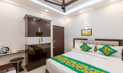 a hotel room with a bed and a desk at Treebo Premium Cochin Airport, 5 min From Cochin Airport in Ernakulam