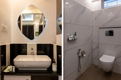 a bathroom with a sink and a toilet and a mirror at Treebo Premium Cochin Airport, 5 min From Cochin Airport in Ernakulam