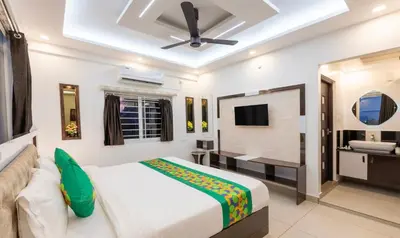 a hotel room with a bed and a television at Treebo Premium Cochin Airport, 5 min From Cochin Airport in Ernakulam