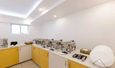 a kitchen with several pots and pans on a counter at Treebo Premium Cochin Airport, 5 min From Cochin Airport in Ernakulam