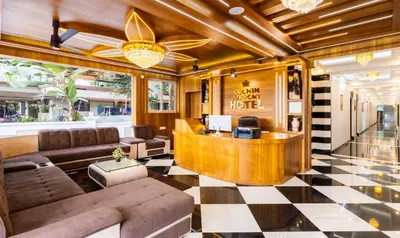 a lobby with a reception desk and a checkered floor at Treebo Premium Cochin Airport, 5 min From Cochin Airport in Ernakulam