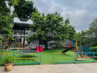 a playground with a slide and a trampoline at Heaven Hills resorts in Vythiri
