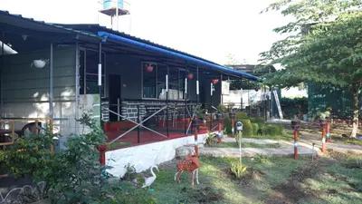 a house with some animals standing outside of it at Wild Tusker Homestay Masinagudi by LexStays in Masinagudi