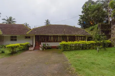 a house with a porch and a grass yard at The Anexure - Great Estate Stay for Remote Work in Siddapur