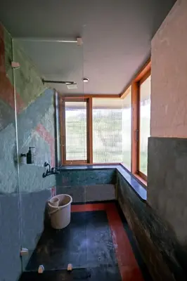 a bathroom with a bath tub and a sink at Cove by Raho - Nestled Away Retreat in Siddapur