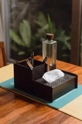 a black box with a bottle on a table at Tool House - Great Estate Stay for Remote Work in Siddapur
