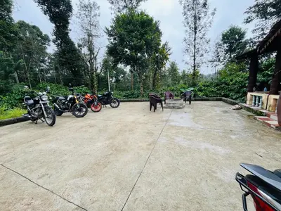 a group of motorcycles parked in a parking lot at Preetham Homestay in Kushālnagar