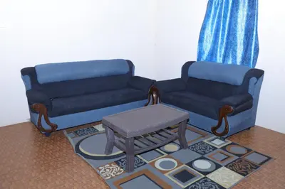 a living room with a couch and a coffee table at Coconut Grove villa by Shivalaya Stays in Alāndurai