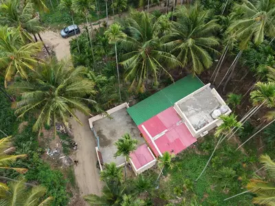 an aerial view of a house with palm trees at Coconut Grove villa by Shivalaya Stays in Alāndurai