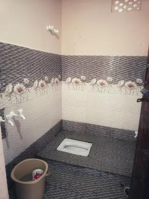a bathroom with pink chickens on the wall and a toilet at Coconut Grove villa by Shivalaya Stays in Alāndurai