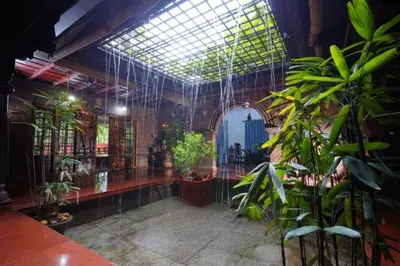a room filled with lots of plants in a building at Illam Heritage inn Bungalow l 4 BHK in Guruvāyūr