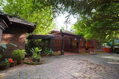 a house with a brick driveway in front of it at Illam Heritage inn Bungalow l 4 BHK in Guruvāyūr